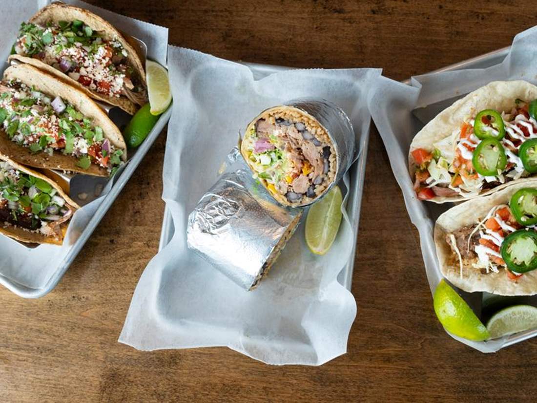 Several tacos and a burrito. 